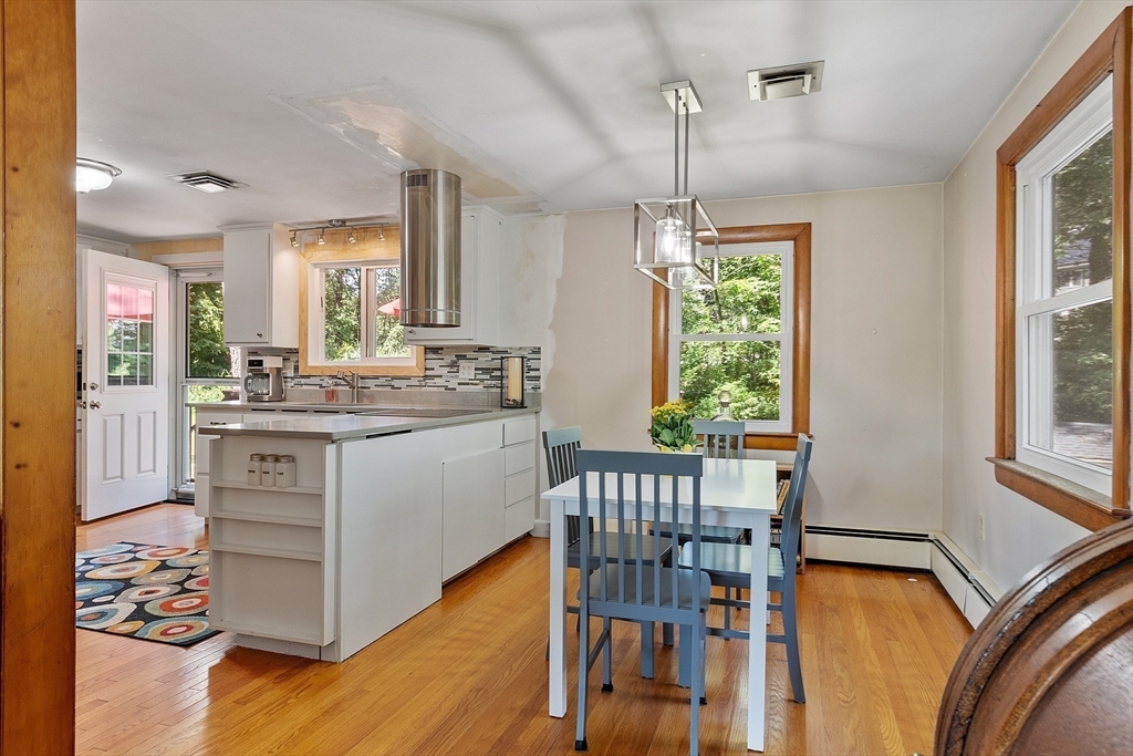 275 Cordaville Road Ashland, MA 01721 - Photo 12 of 39 a kitchen with a table chairs a sink dishwasher window and cabinets