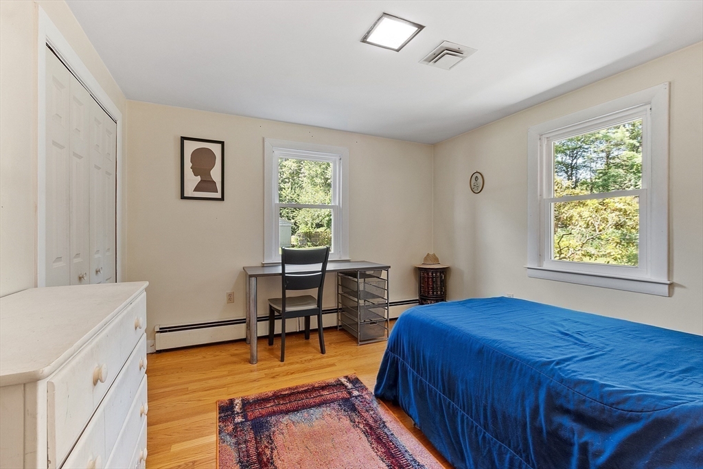 275 Cordaville Road Ashland, MA 01721 - Photo 25 of 39 a bedroom with a bed and a table in it with window