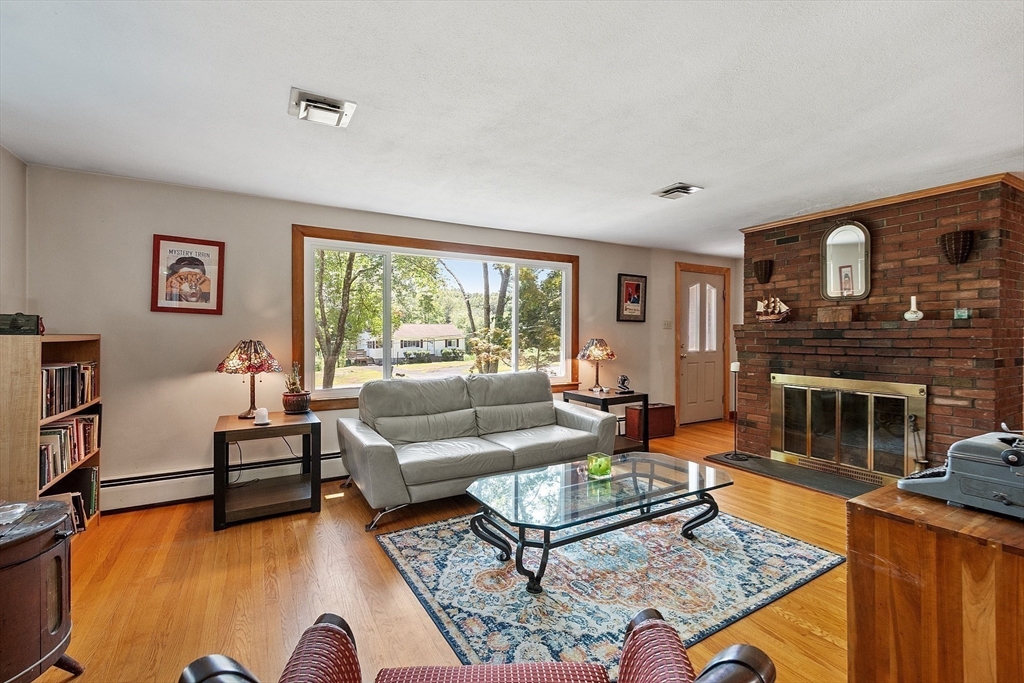 275 Cordaville Road Ashland, MA 01721 - Photo 8 of 39 a living room with furniture and a fireplace