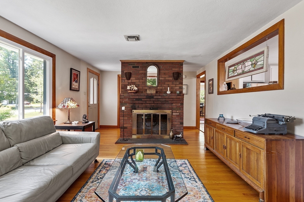 275 Cordaville Road Ashland, MA 01721 - Photo 9 of 39 a living room with furniture a fireplace and a large window