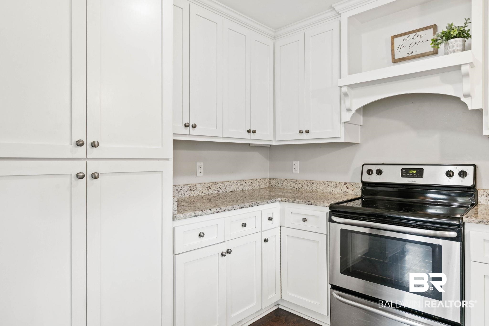 22810 High Ridge Road Fairhope, AL 36532 - Photo 29 of 78 Kitchen featuring white shaker-style cabinetry, stainless steel range, and speckled countertops
