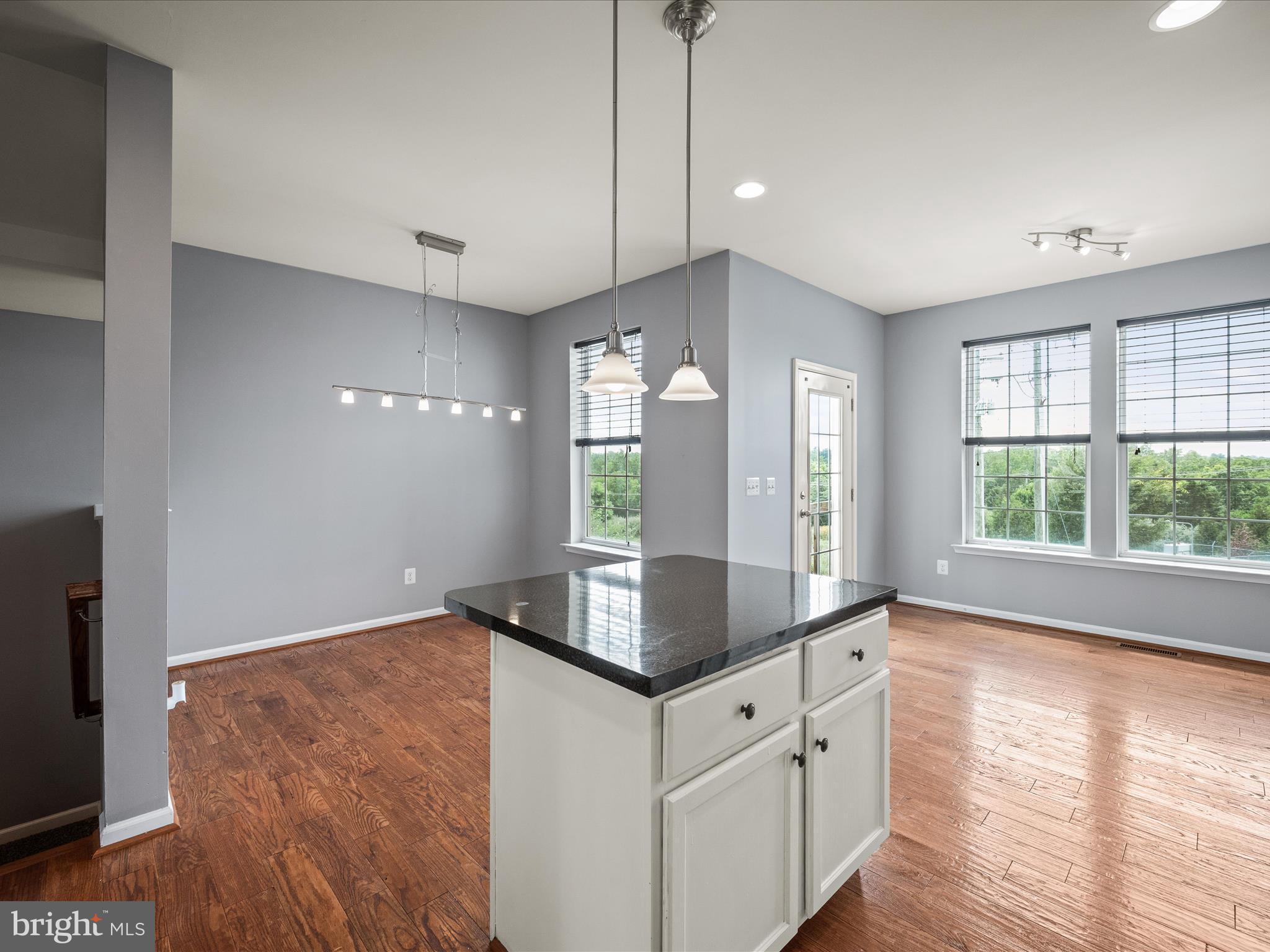 247 Schramm Loop Stephens City, VA 22655 - Photo 12 of 34 a kitchen with granite countertop a stove a sink and a large window
