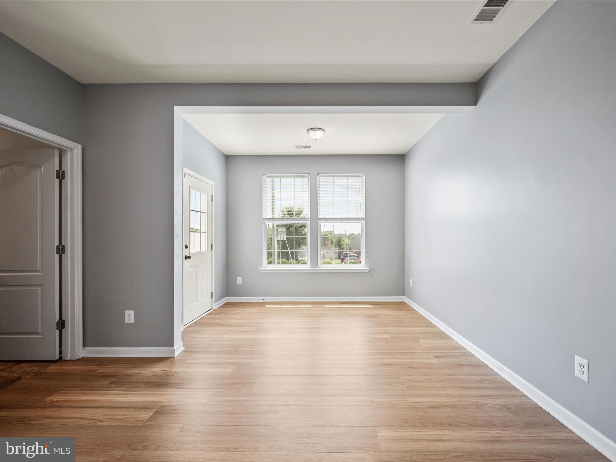 247 Schramm Loop Stephens City, VA 22655 - Photo 4 of 34 a view of an empty room with wooden floor and a window
