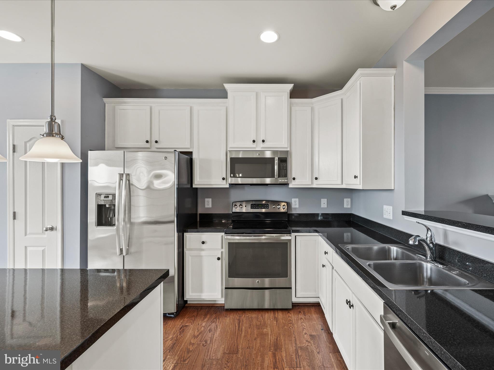 247 Schramm Loop Stephens City, VA 22655 - Photo 8 of 34 a kitchen with granite countertop a sink stove and refrigerator
