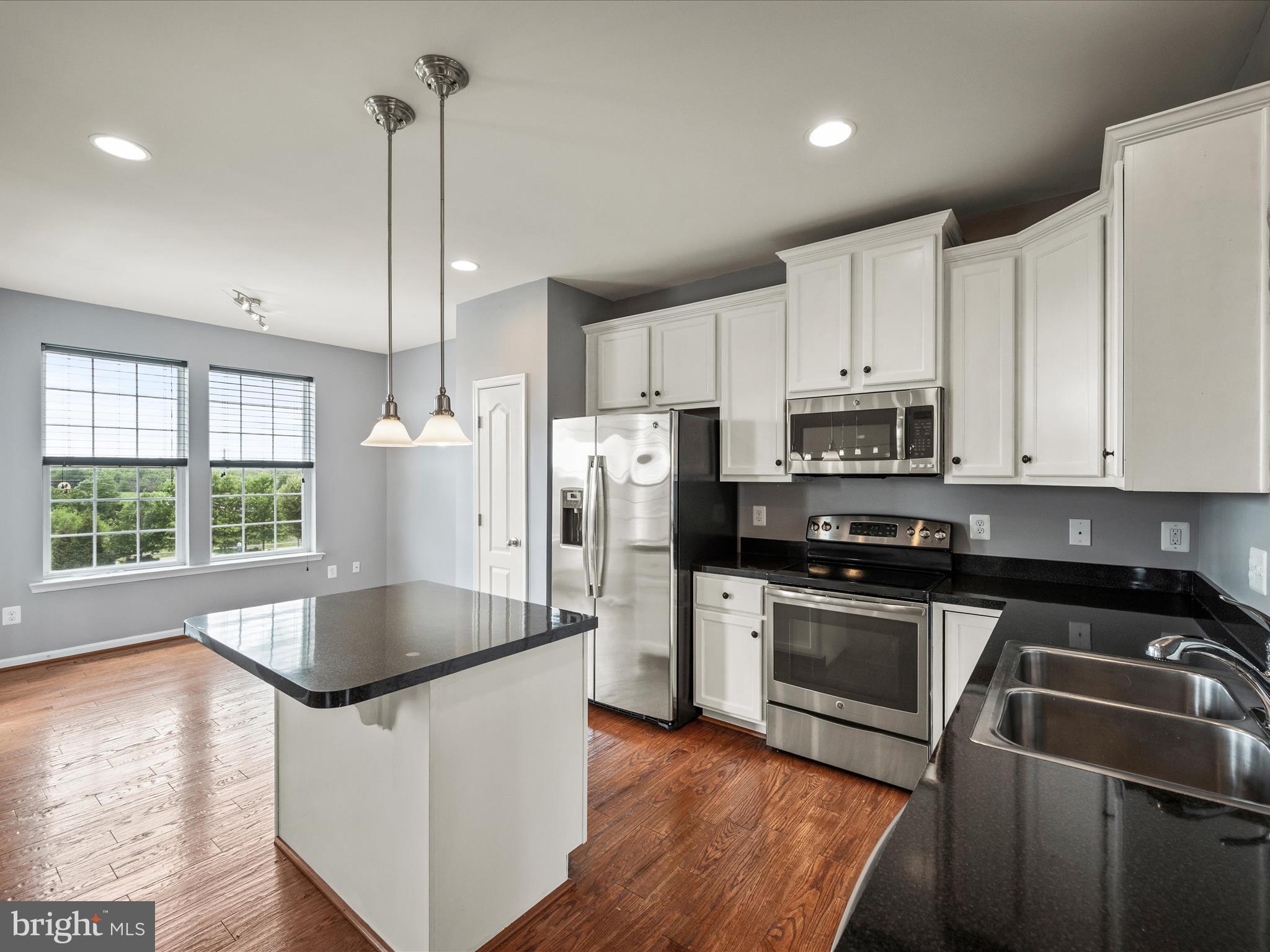 247 Schramm Loop Stephens City, VA 22655 - Photo 9 of 34 a kitchen with stainless steel appliances granite countertop a sink a stove a refrigerator a center island and wooden floor