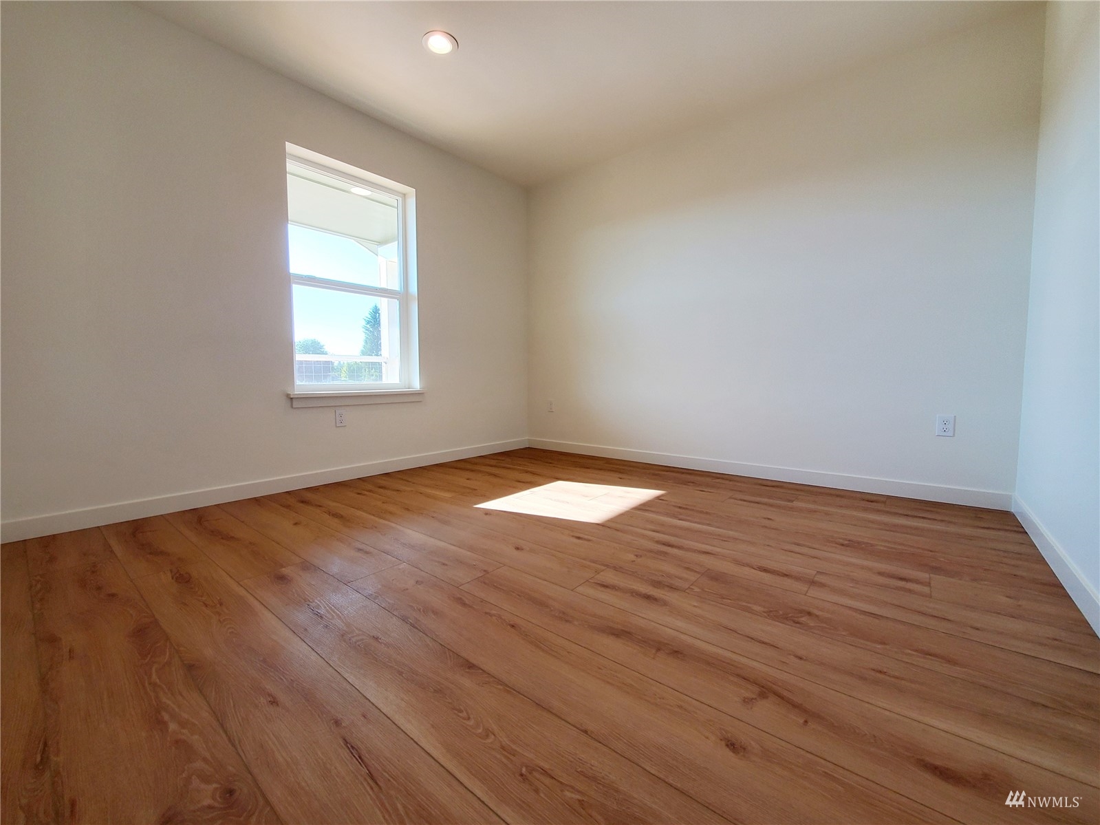 440 Merchants Road Forks, WA 98331 - Photo 15 of 27 an empty room with wooden floor and windows
