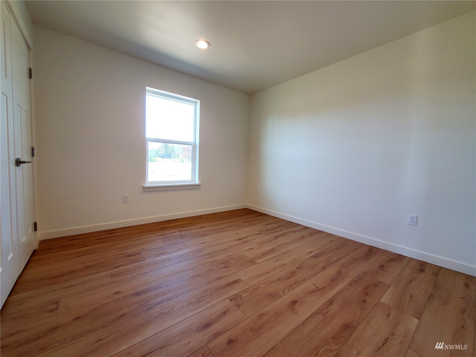 440 Merchants Road Forks, WA 98331 - Photo 17 of 27 an empty room with wooden floor and windows