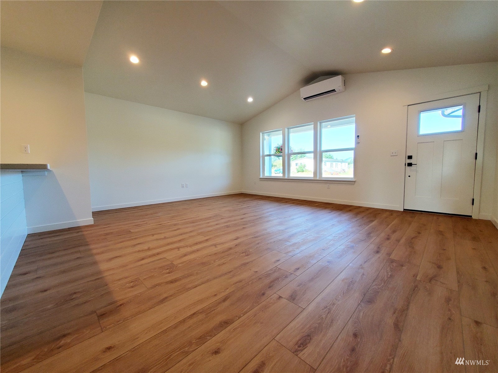 440 Merchants Road Forks, WA 98331 - Photo 4 of 27 an empty room with wooden floor and windows