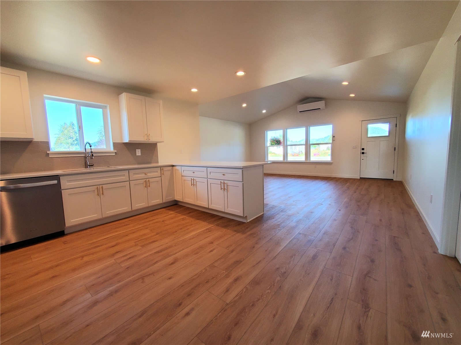 440 Merchants Road Forks, WA 98331 - Photo 5 of 27 a large kitchen with wooden floors and wooden cabinets