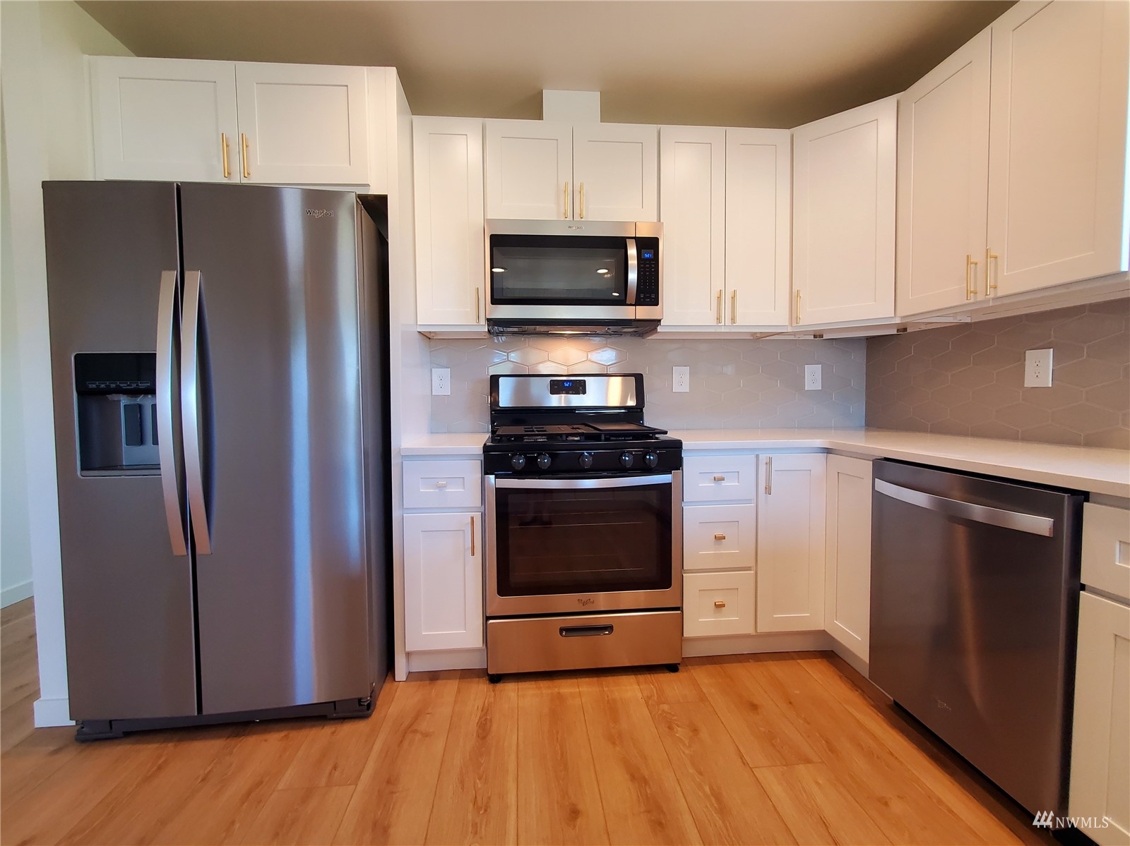 440 Merchants Road Forks, WA 98331 - Photo 8 of 27 a kitchen with granite countertop white cabinets and stainless steel appliances