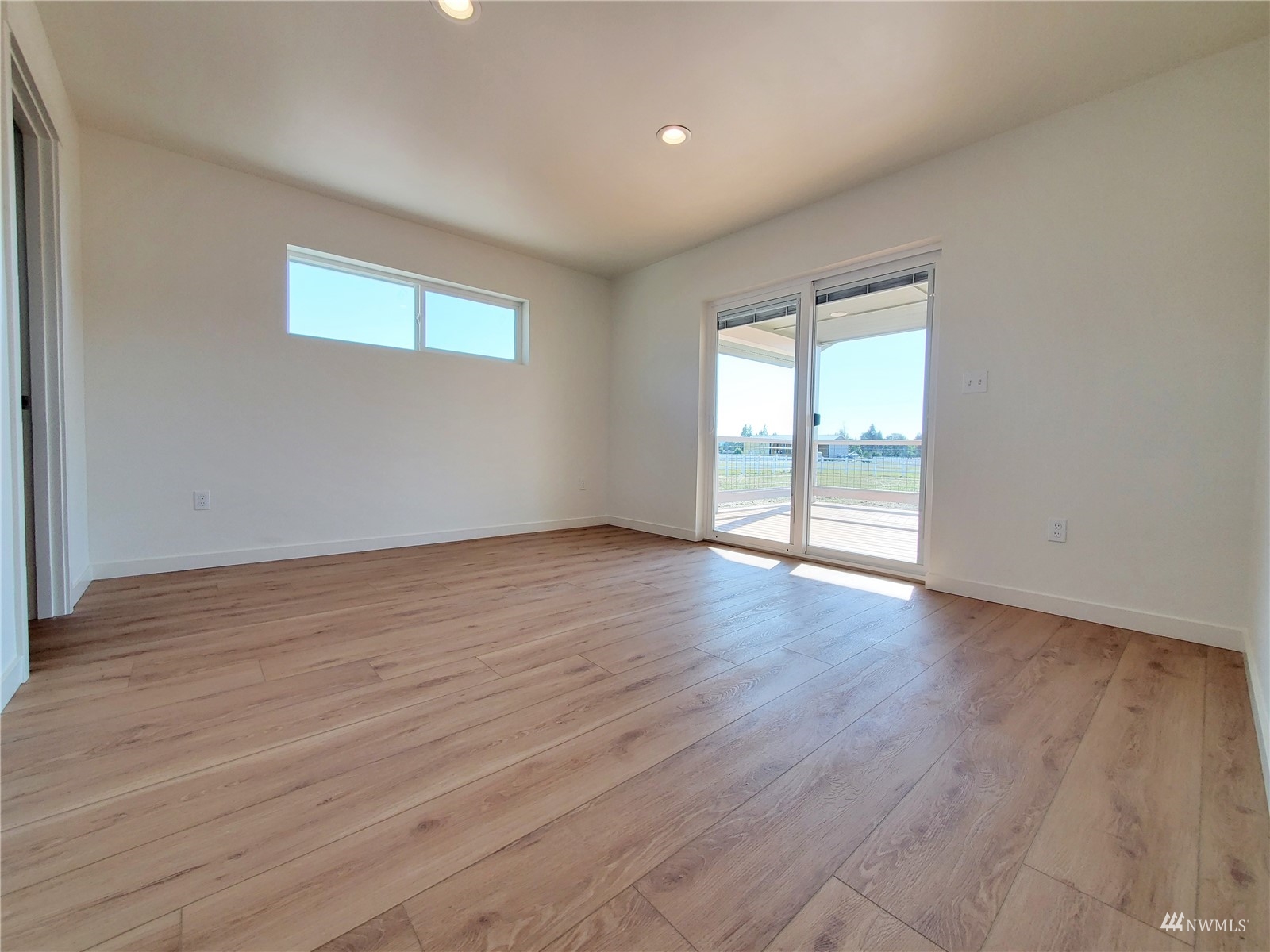 440 Merchants Road Forks, WA 98331 - Photo 9 of 27 a view of an empty room with wooden floor and a window