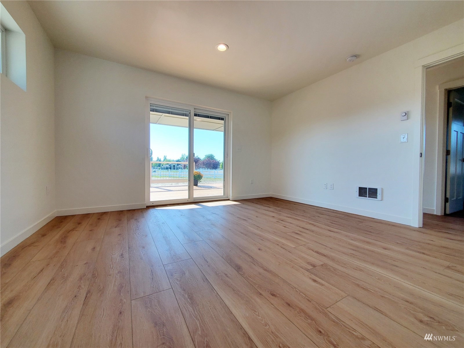 440 Merchants Road Forks, WA 98331 - Photo 10 of 27 a view of an empty room with wooden floor and window