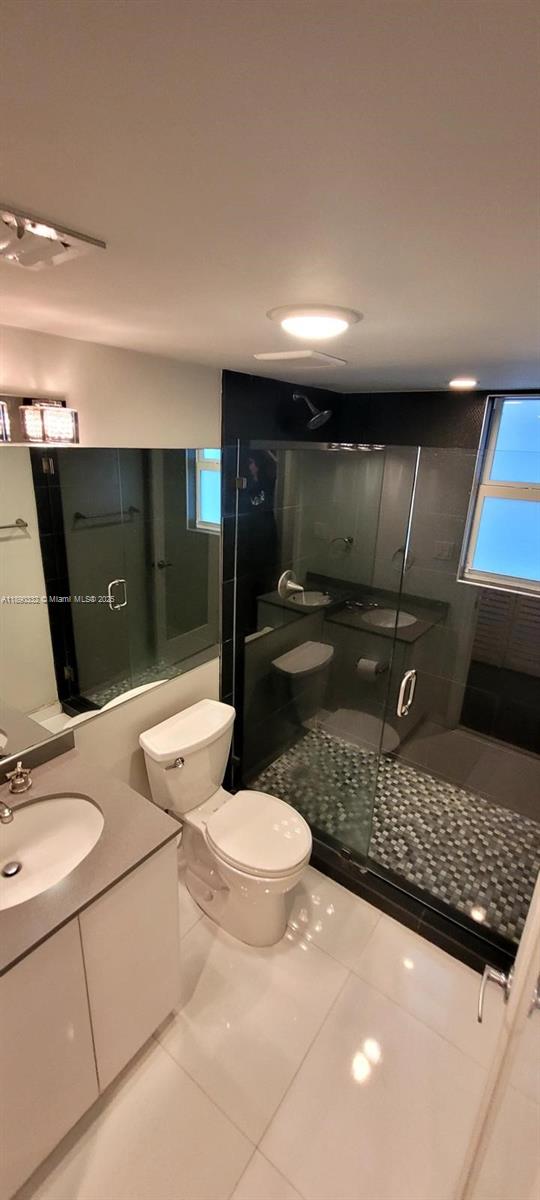 7333 Dickens Avenue, Unit 1 Miami Beach, FL 33141 - Photo 8 of 12 a bathroom with a sink a toilet and mirror