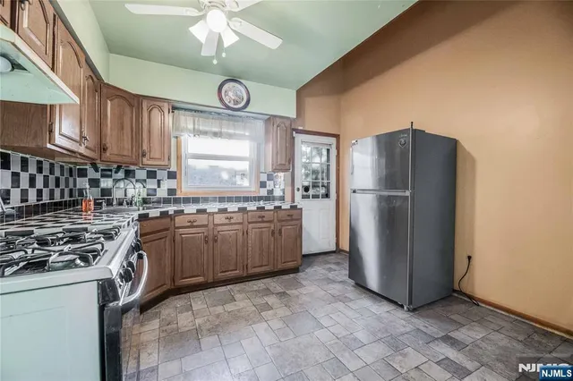 a kitchen with refrigerator cabinets and a sink