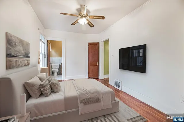 a bedroom with a large bed and a window