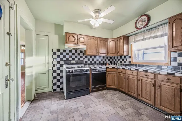 a kitchen with stainless steel appliances granite countertop a stove sink and cabinets