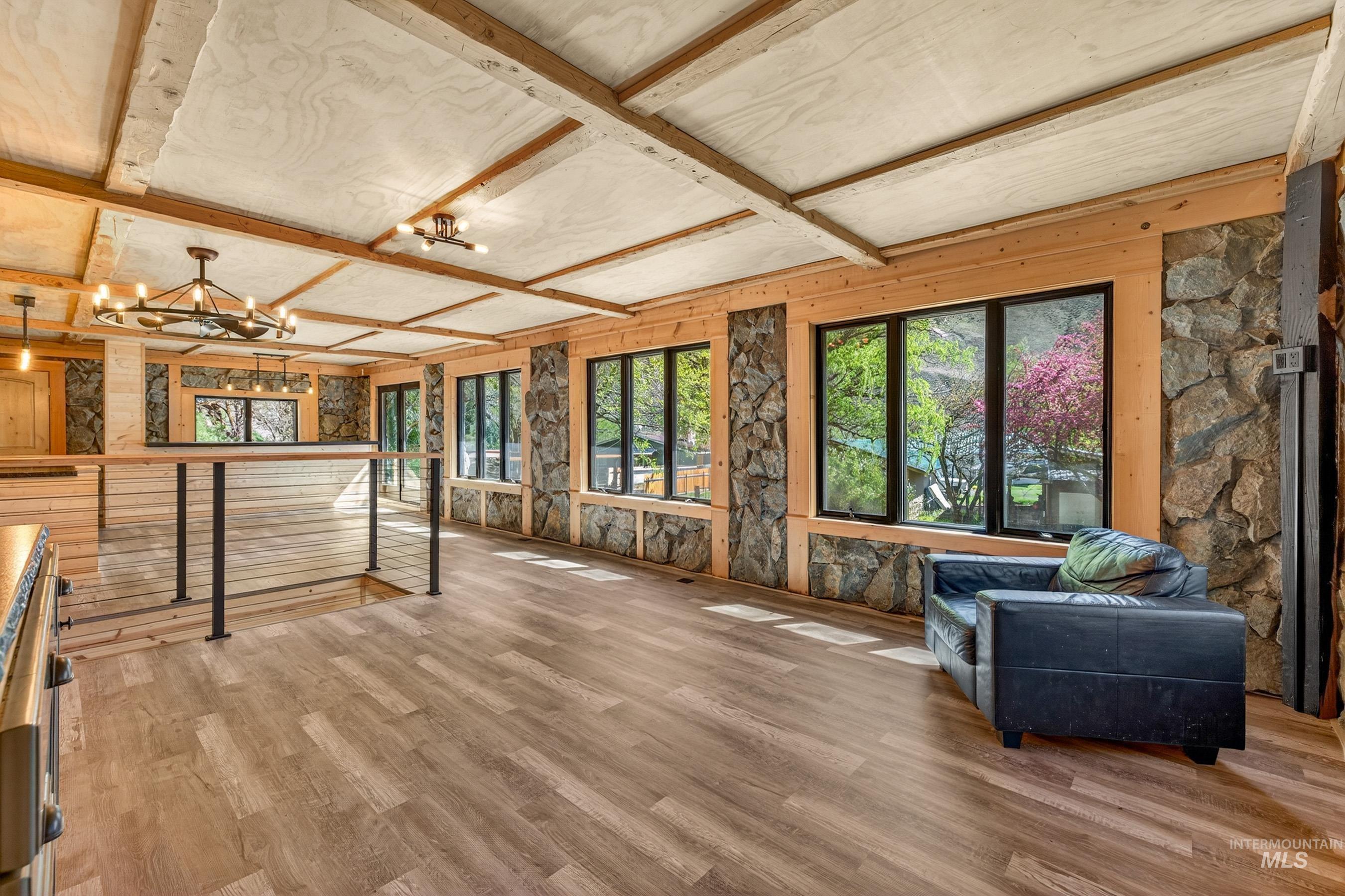 543 North Main Street Riggins, ID 83549 - Photo 16 of 46 Living area with light wood finished floors, coffered ceiling, and a chandelier