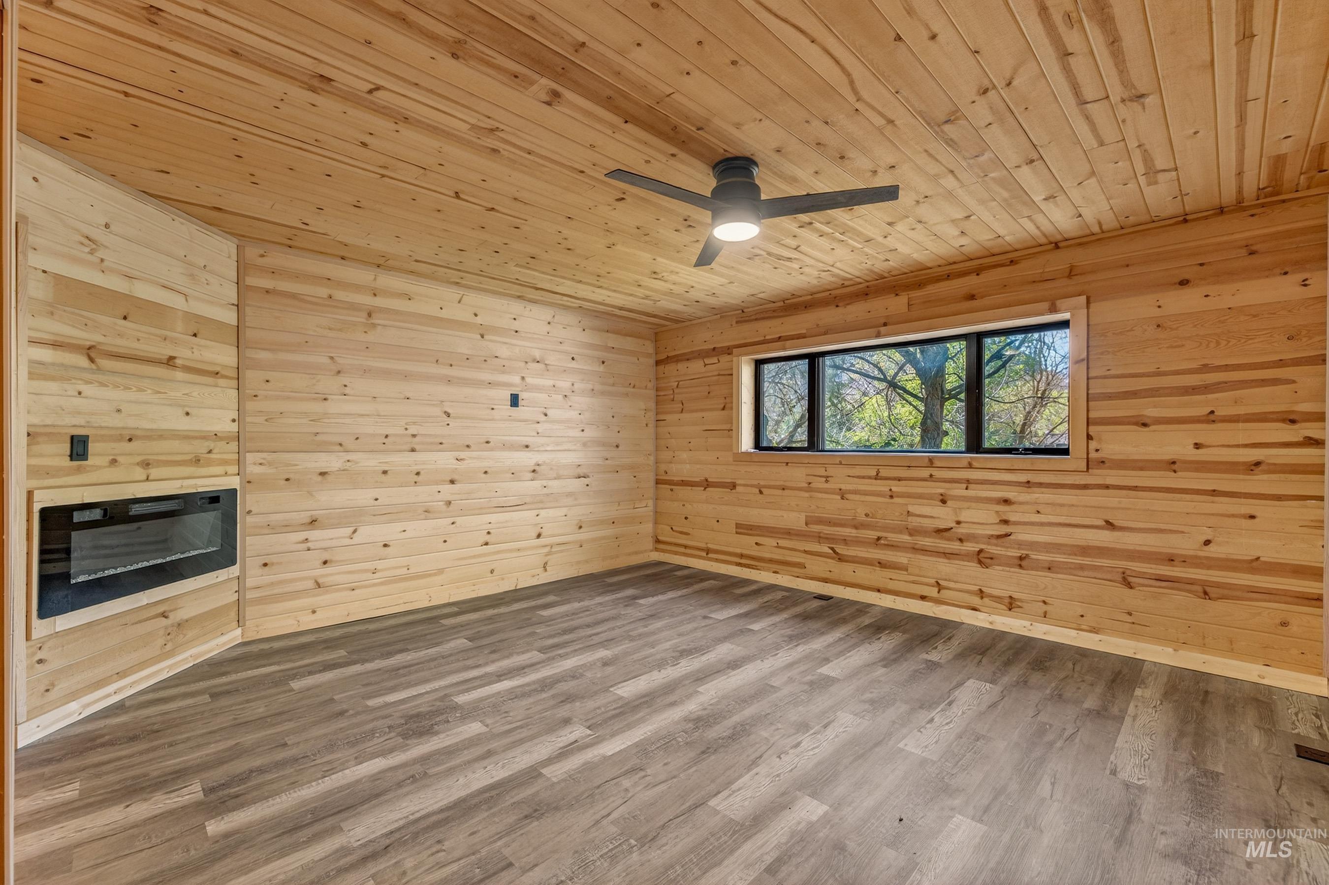543 North Main Street Riggins, ID 83549 - Photo 20 of 46 Spare room featuring wood walls, wood ceiling, wood finished floors, and ceiling fan