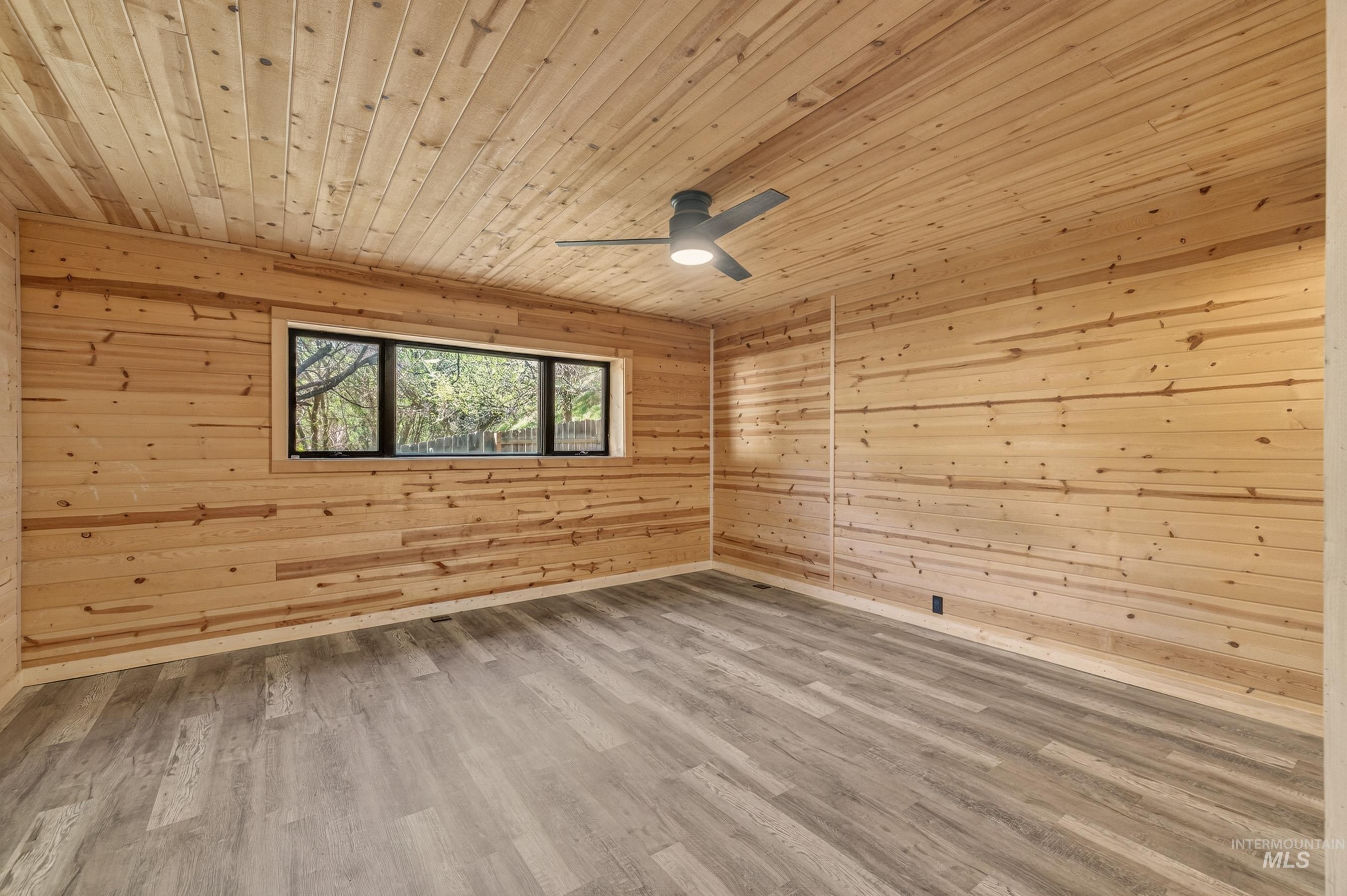 543 North Main Street Riggins, ID 83549 - Photo 21 of 46 Unfurnished room with wood walls, wooden ceiling, light wood-type flooring, and ceiling fan