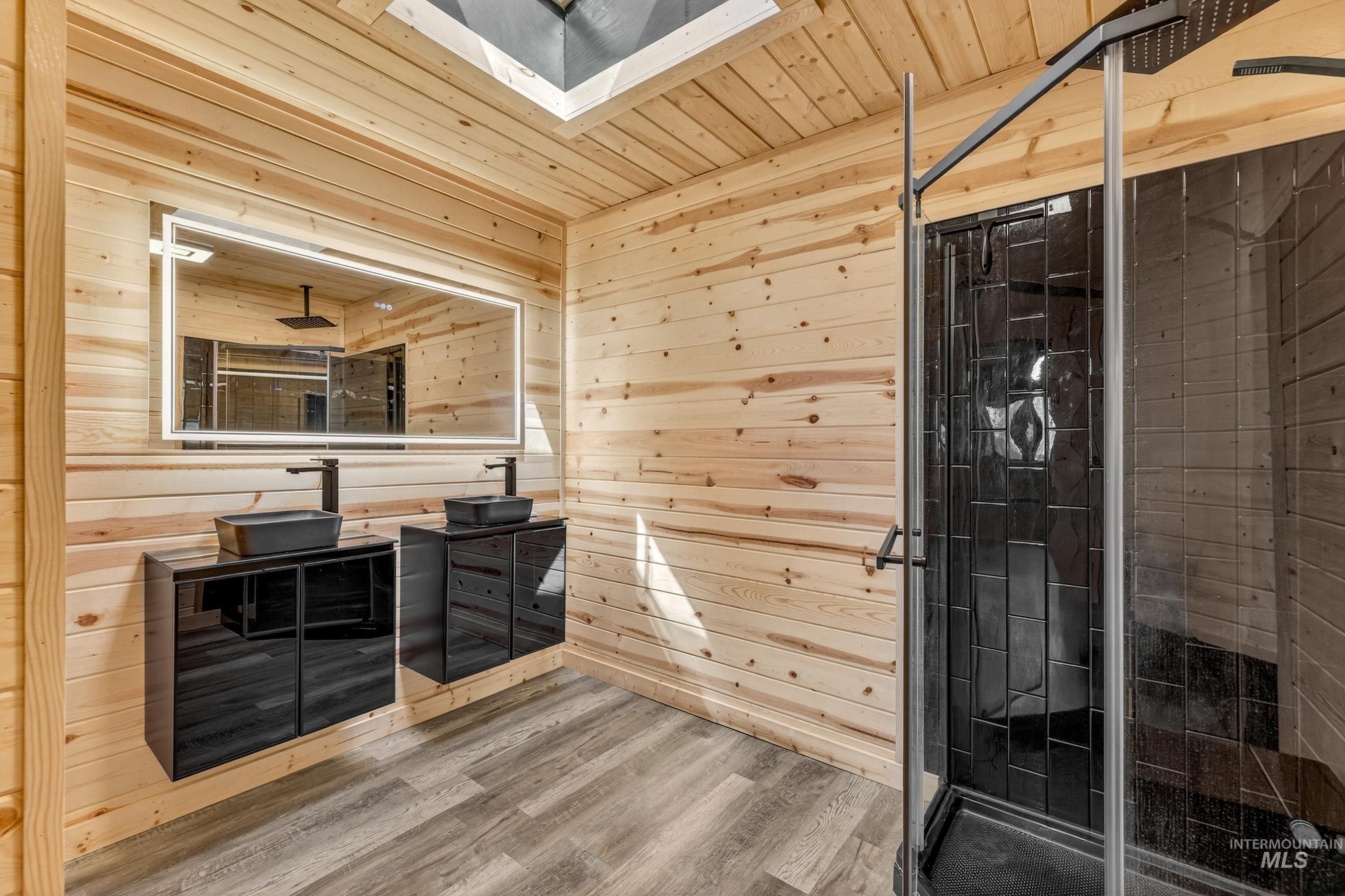 543 North Main Street Riggins, ID 83549 - Photo 23 of 46 Bathroom featuring vanity, wooden walls, a shower stall, wooden ceiling, and wood finished floors