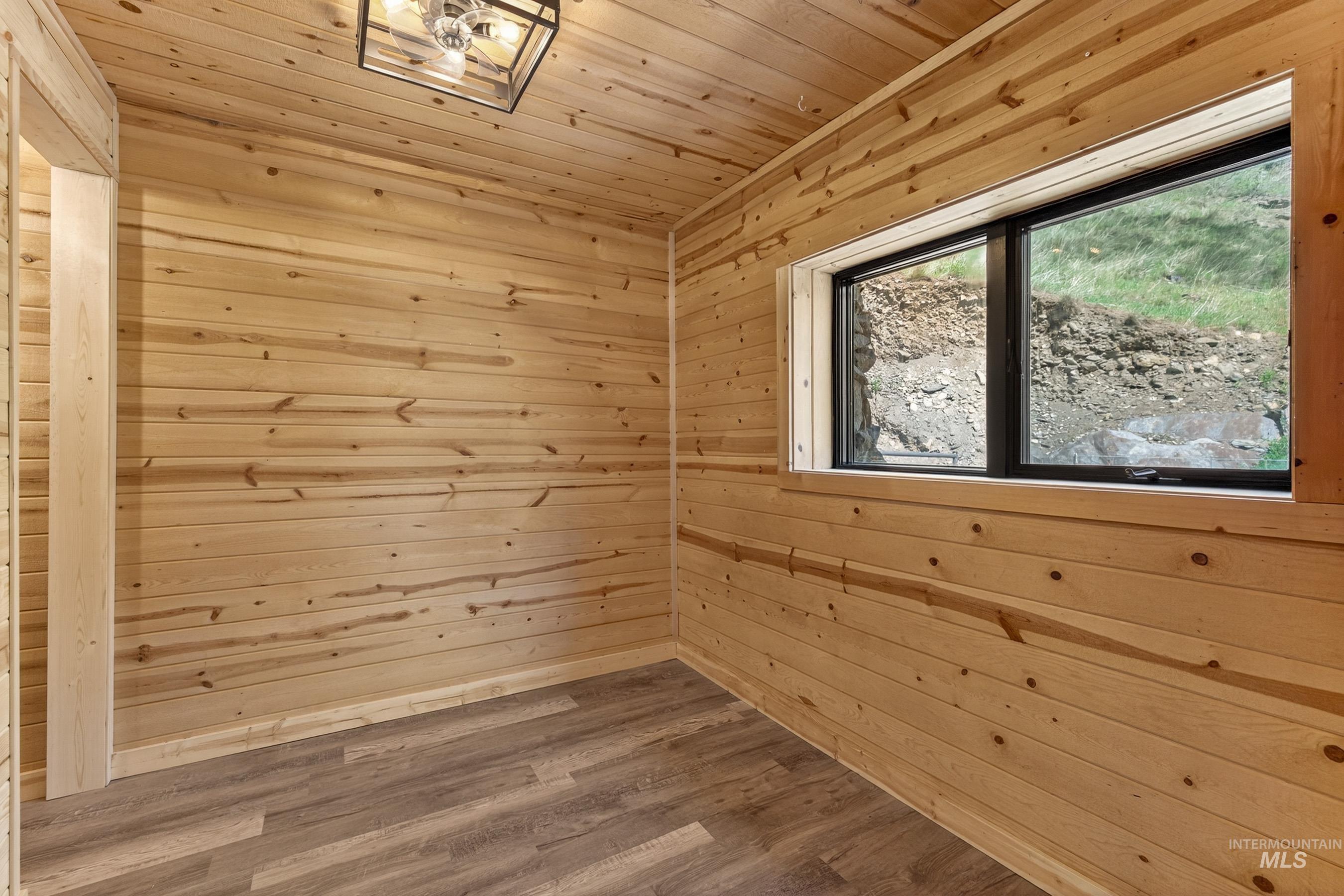 543 North Main Street Riggins, ID 83549 - Photo 28 of 46 Empty room with wooden ceiling, wood walls, and wood finished floors