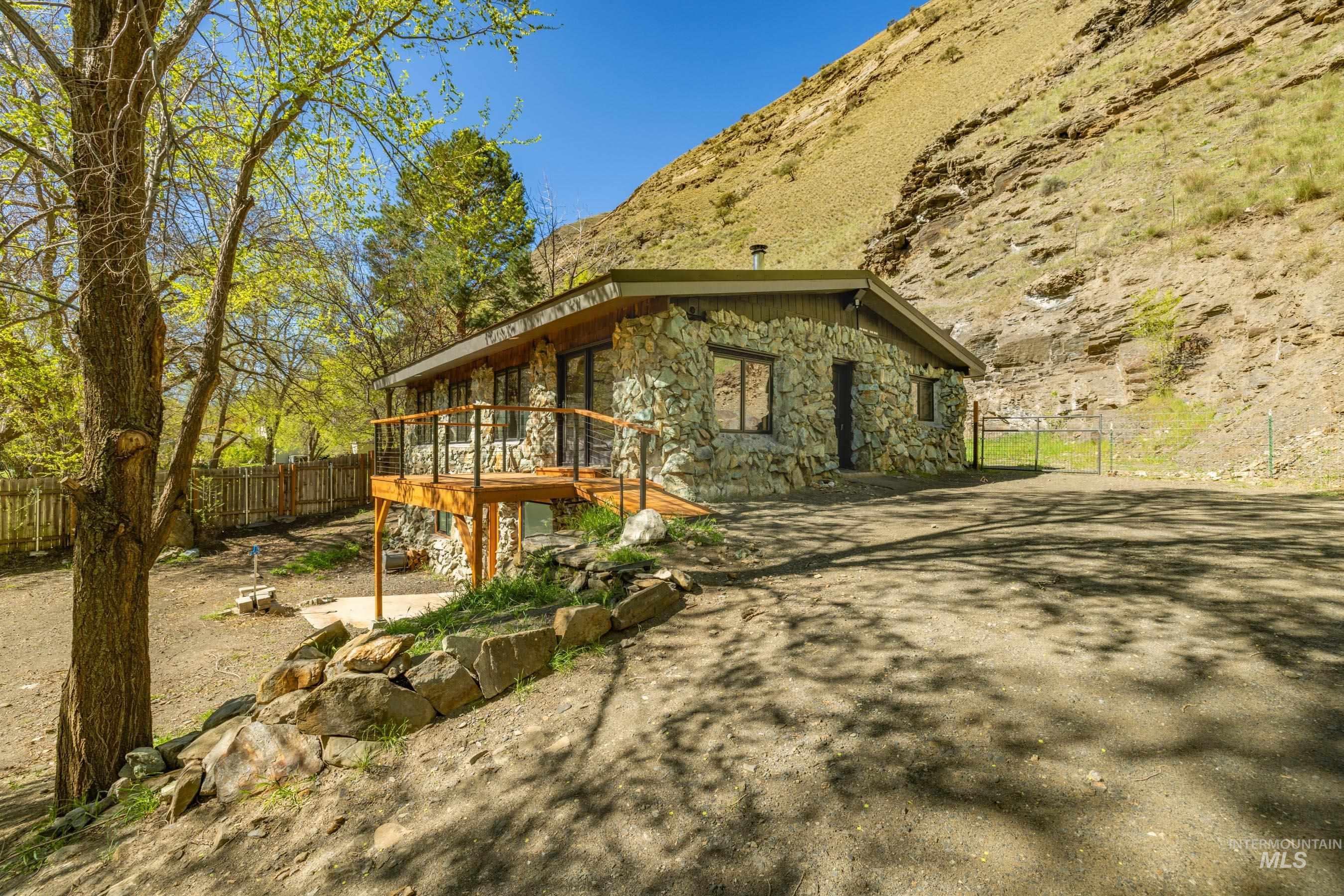 543 North Main Street Riggins, ID 83549 - Photo 3 of 46 View of home's exterior with a wooden deck and stone siding