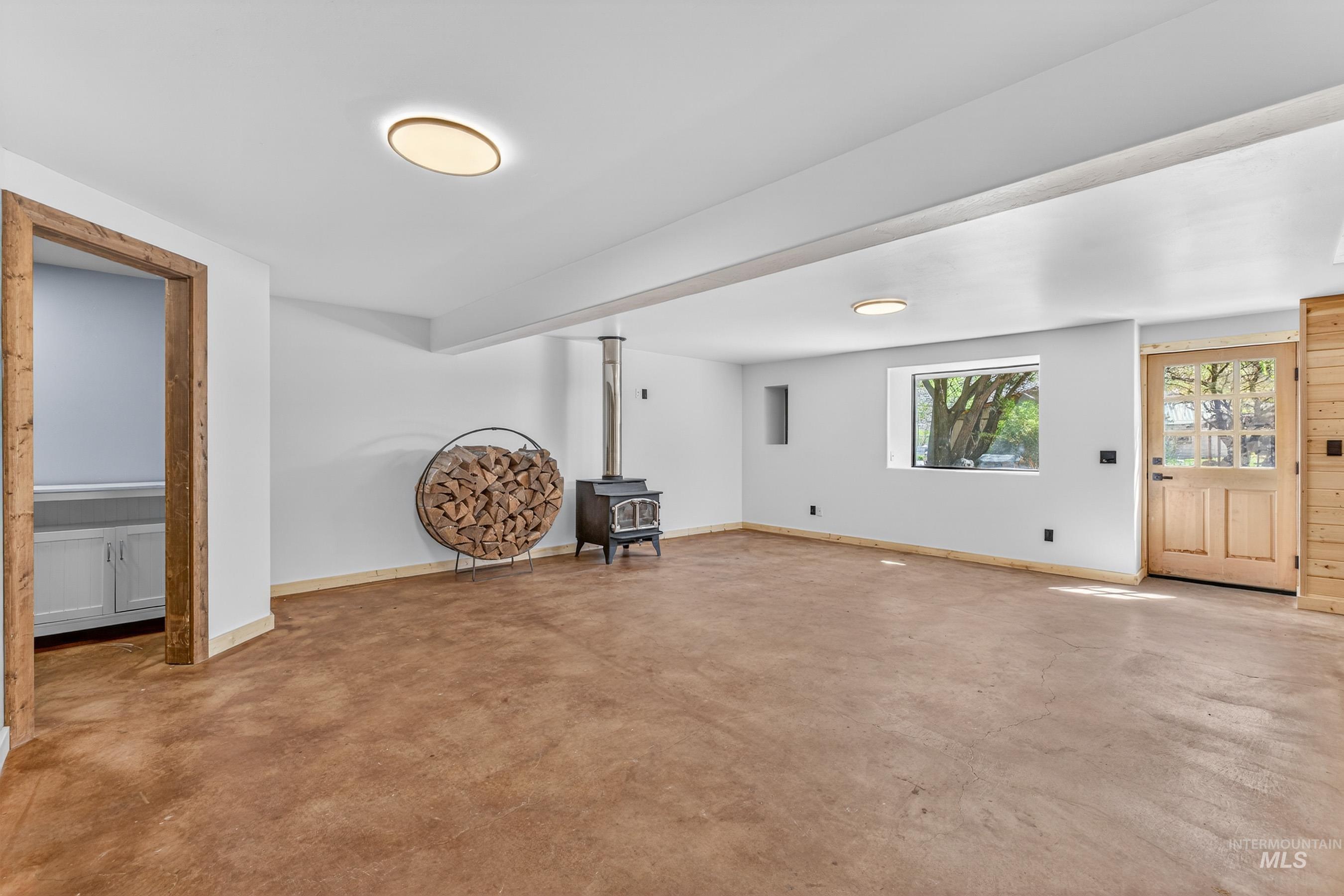 543 North Main Street Riggins, ID 83549 - Photo 31 of 46 Basement featuring a wood stove and baseboards