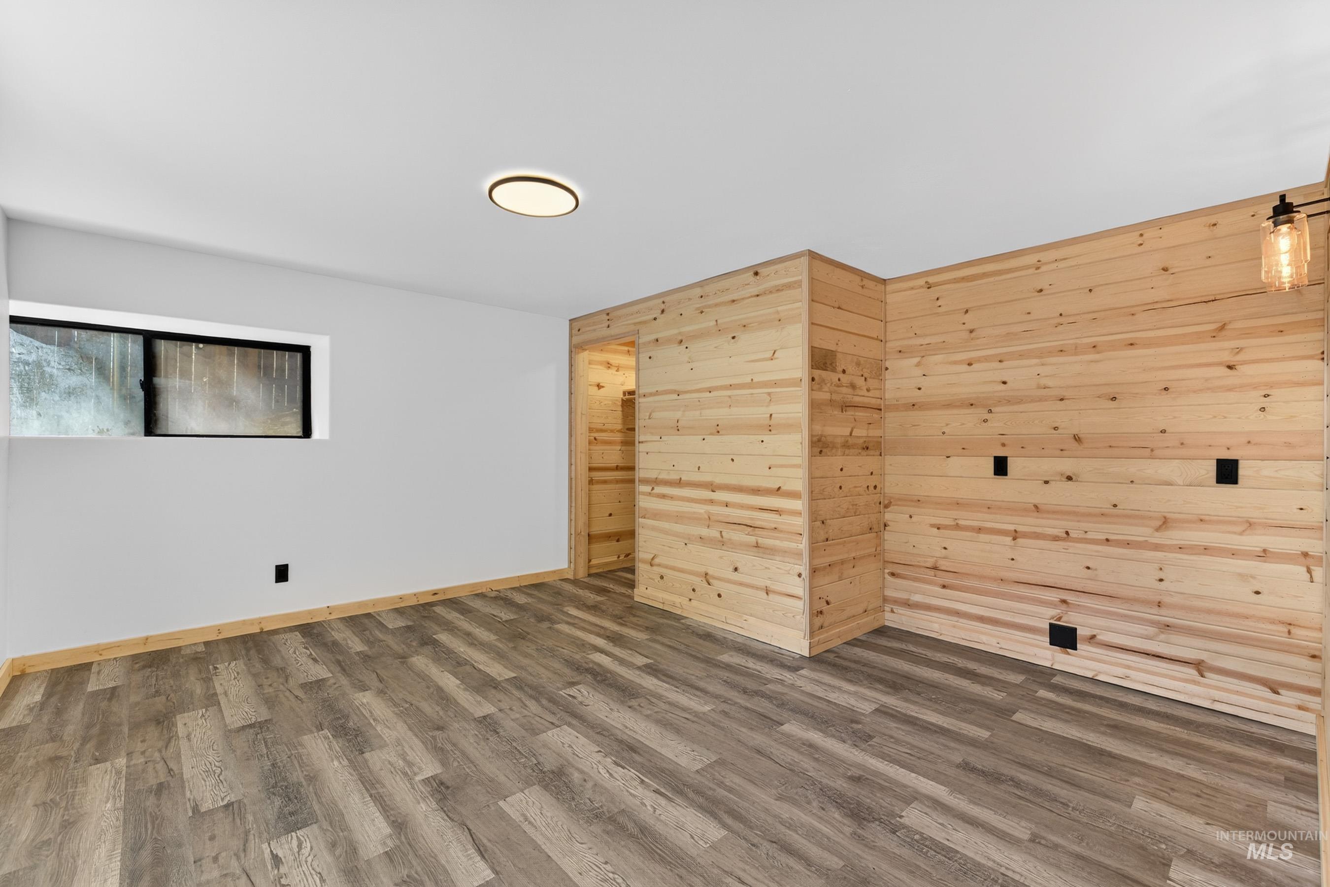 543 North Main Street Riggins, ID 83549 - Photo 37 of 46 Unfurnished room with wood walls and dark wood finished floors