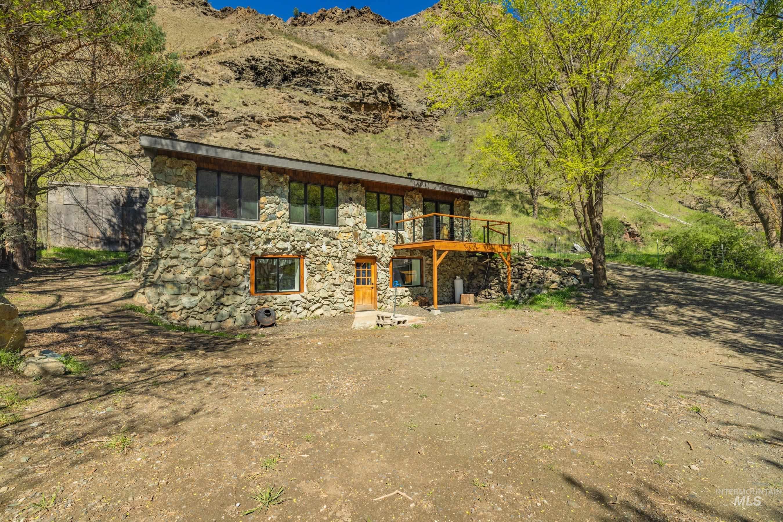 543 North Main Street Riggins, ID 83549 - Photo 42 of 46 View of front of property featuring a patio, stone siding, and a wooden deck