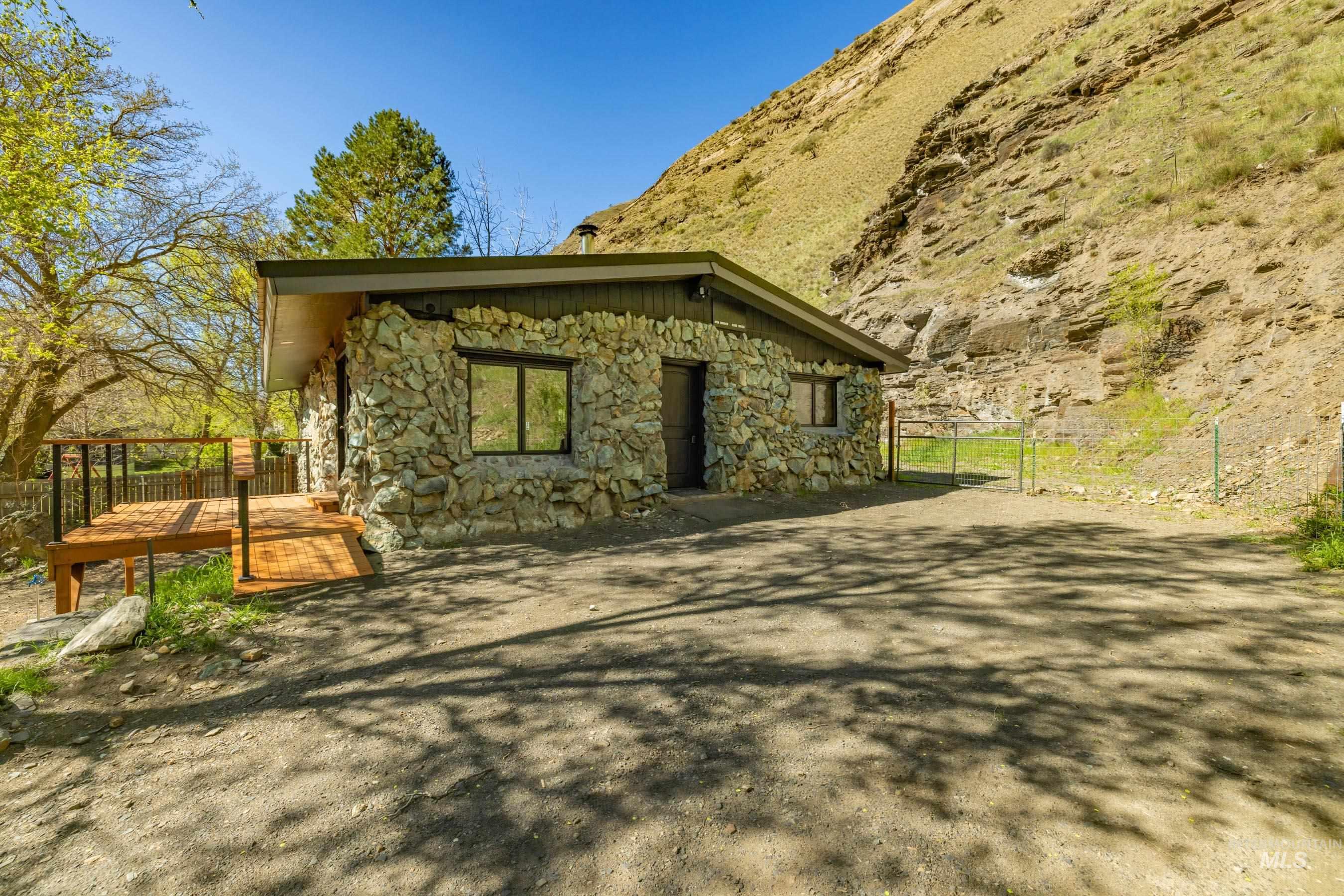 543 North Main Street Riggins, ID 83549 - Photo 7 of 46 View of side of property with stone siding and a gate