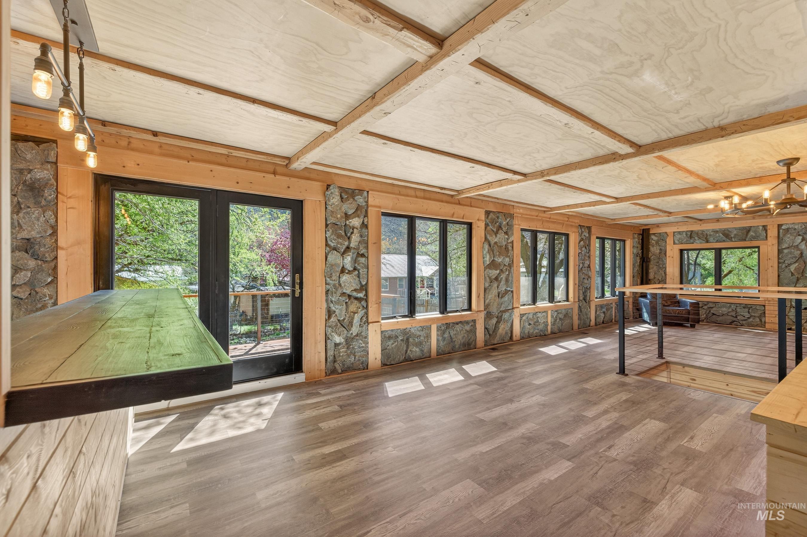 543 North Main Street Riggins, ID 83549 - Photo 10 of 46 Unfurnished sunroom featuring wood finished floors, french doors, and a chandelier