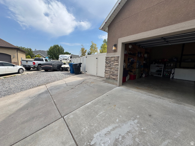 1237 South 260 West Payson, UT 84651 - Photo 81 of 81 Stucco exterior with stone veneer accents, an attached garage, and a gravel parking area