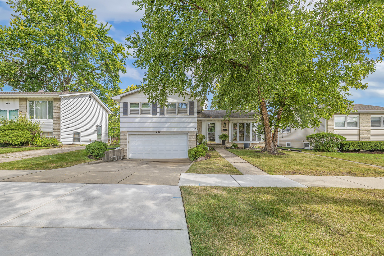 732 Sandy Lane Des Plaines, IL 60016 - Photo 17 of 17 a front view of a house with a garden and trees