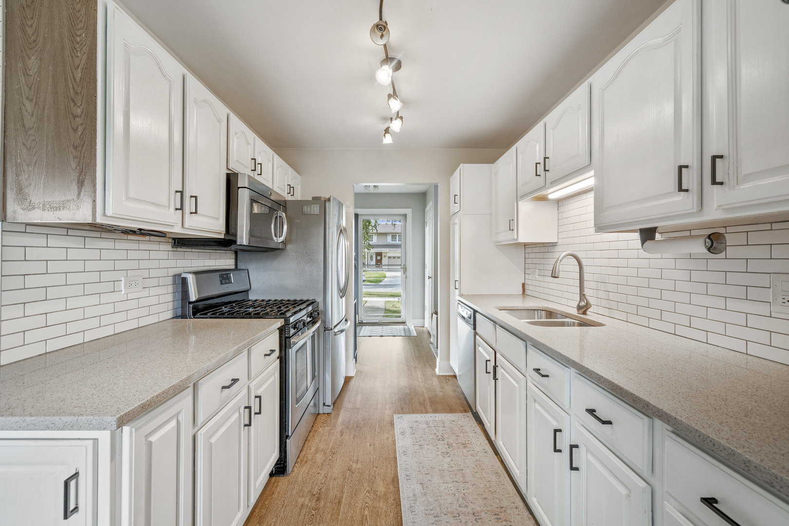 732 Sandy Lane Des Plaines, IL 60016 - Photo 3 of 17 a kitchen with stainless steel appliances granite countertop a sink stove and cabinets