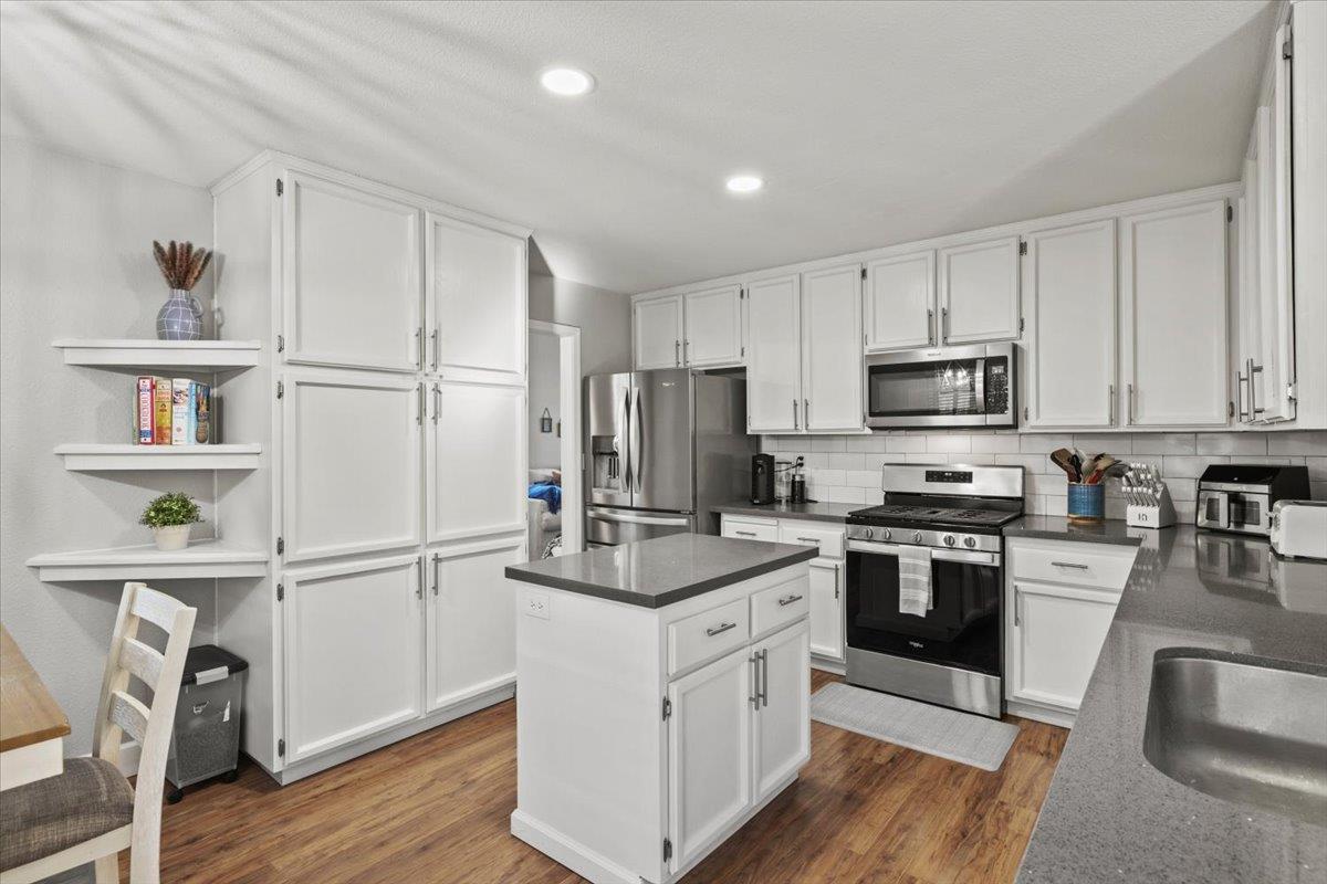 5303 Elgin Hills Way Antelope, CA 95843 - Photo 3 of 33 a kitchen with white cabinets and appliances