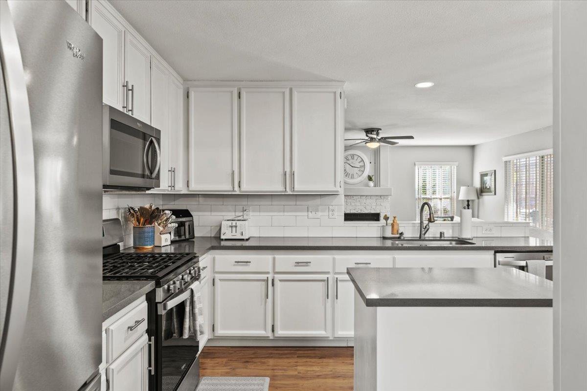 5303 Elgin Hills Way Antelope, CA 95843 - Photo 10 of 33 a kitchen with granite countertop white cabinets and stainless steel appliances