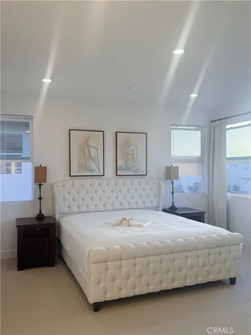 a bedroom with a bed and a night stand