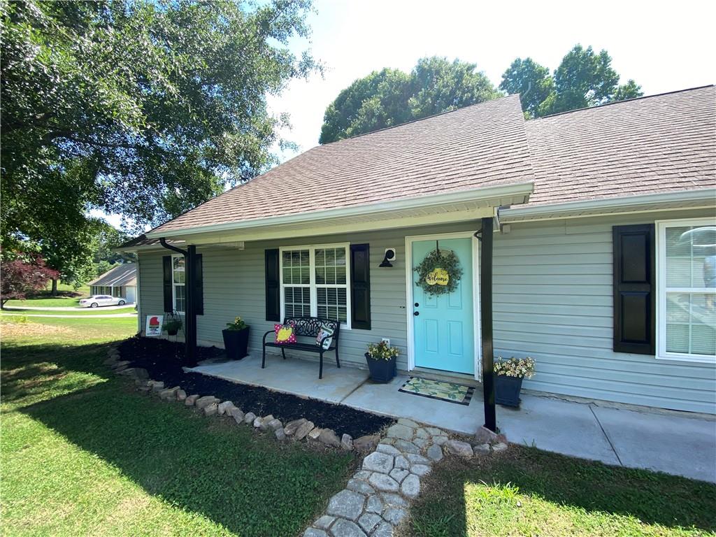 a front view of a house with a garden and patio