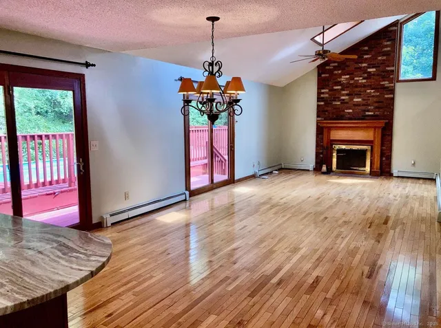 a view of a livingroom with wooden floor a chandelier