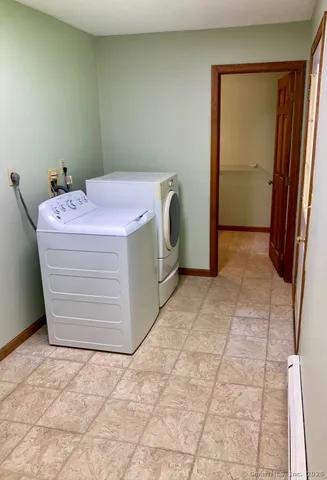 a utility room with a wooden floor washer and dryer