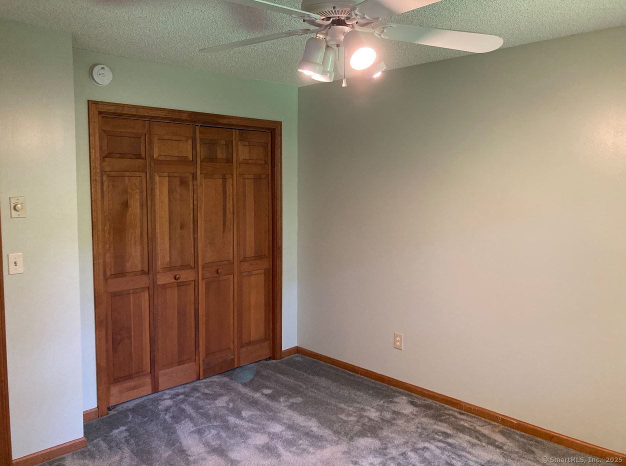 7 Morey Road New Milford, CT 06776 - Photo 16 of 25 an empty room with a chandelier fan