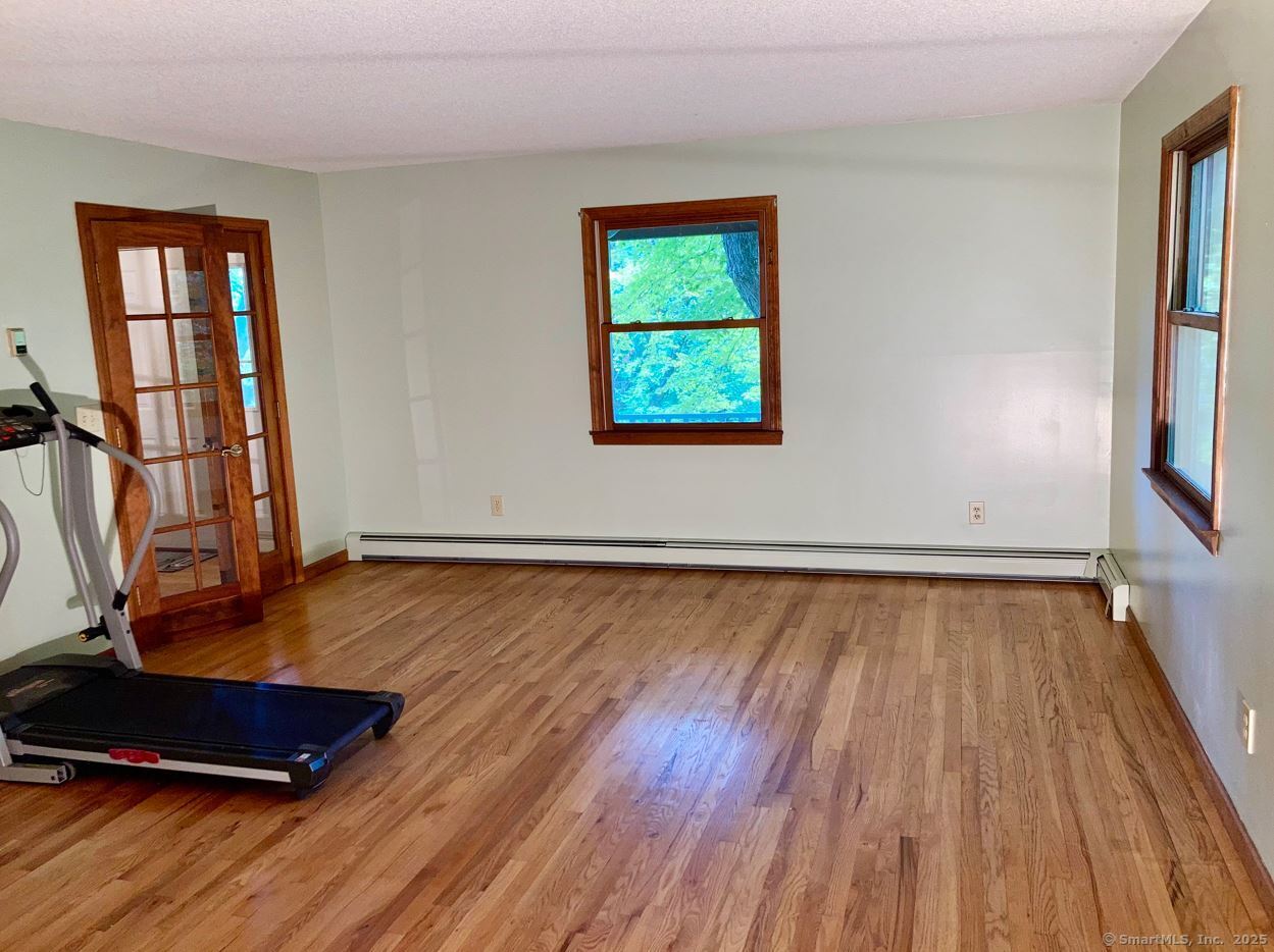 7 Morey Road New Milford, CT 06776 - Photo 7 of 25 an empty room with wooden floor and windows
