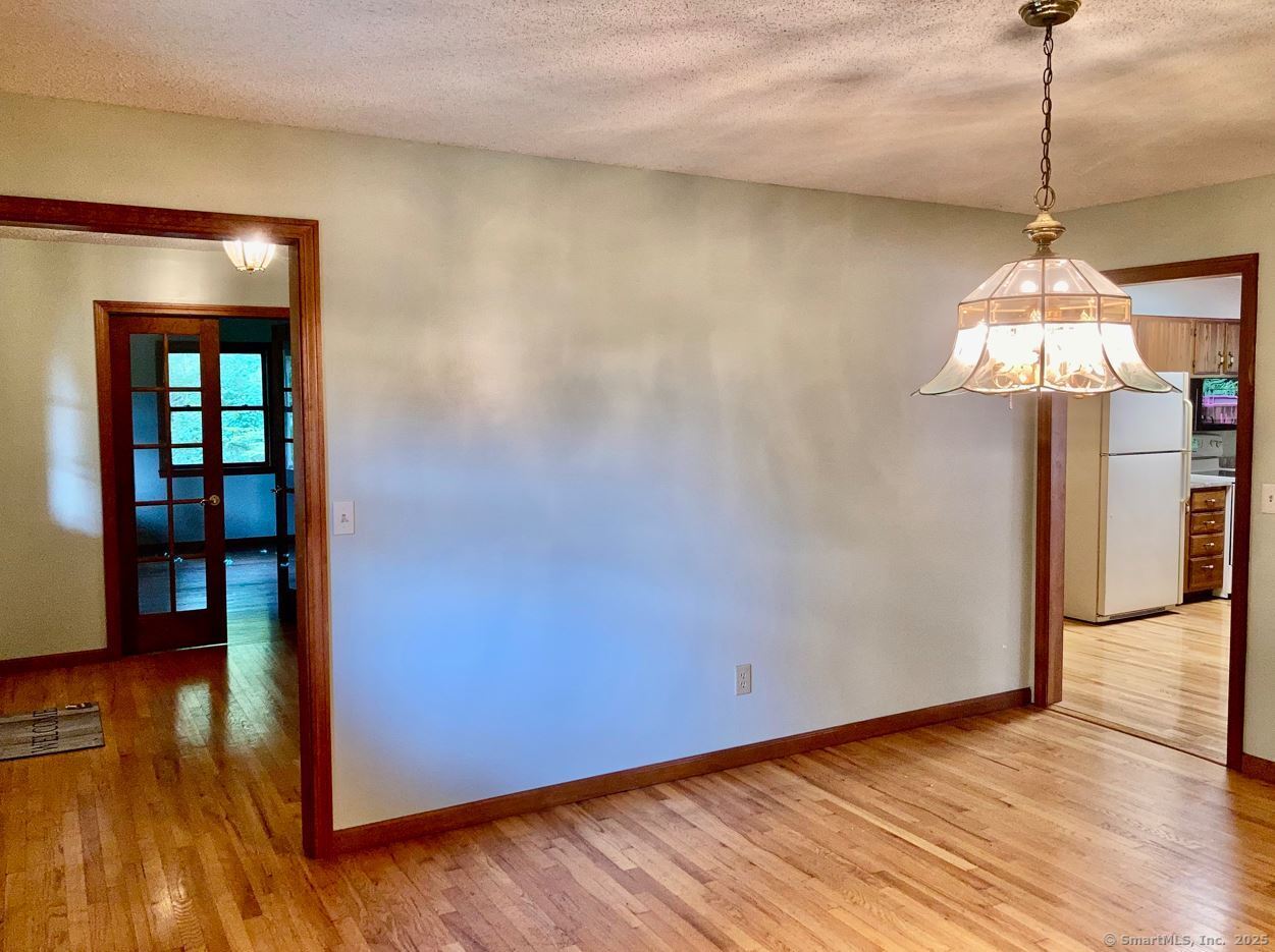 7 Morey Road New Milford, CT 06776 - Photo 8 of 25 a view of a room with wooden floor and chandelier