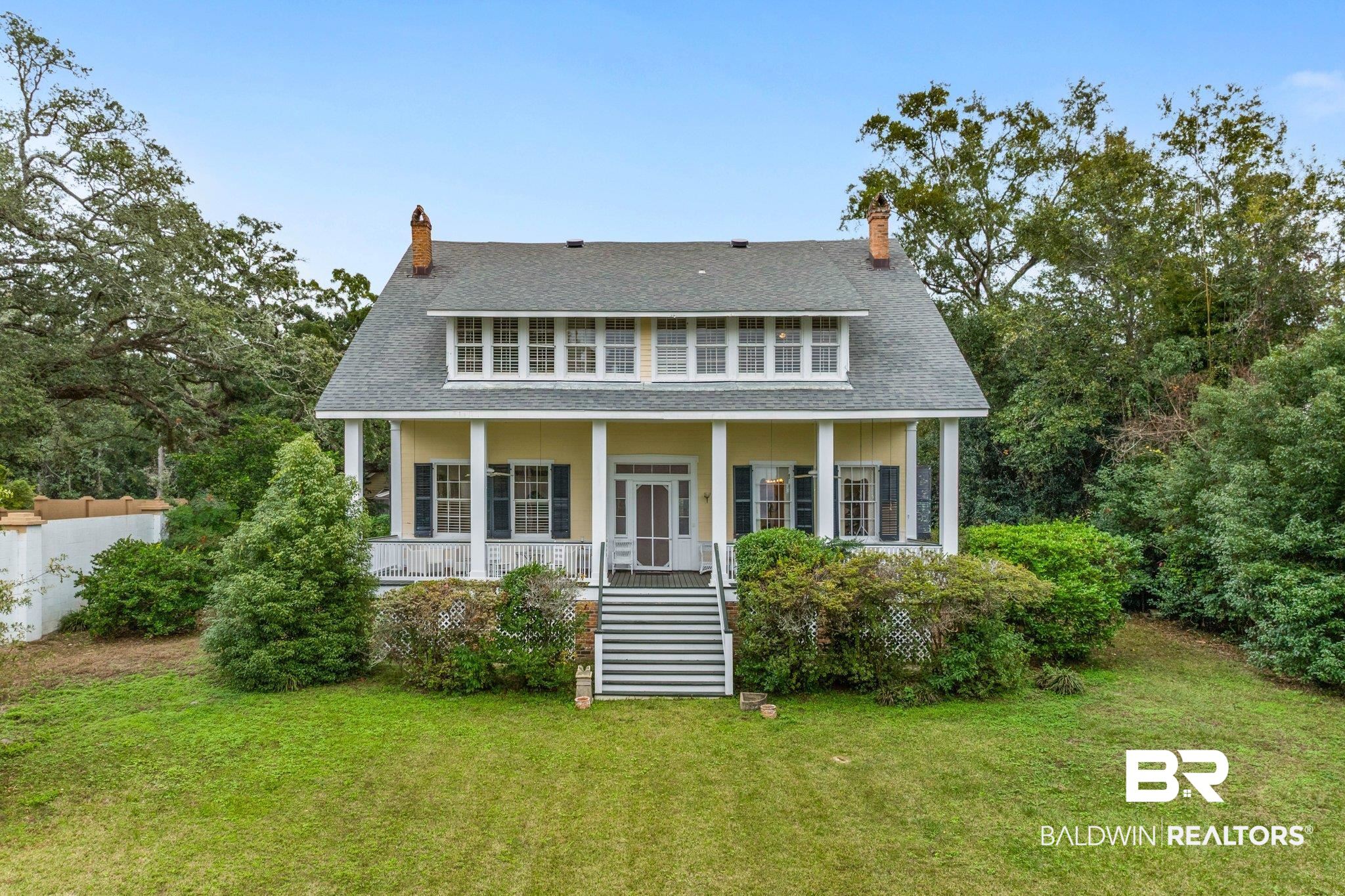 23561 Main Street Fairhope, AL 36532 - Photo 37 of 45 View of front of home featuring stairway, a shingled roof, a chimney, and a porch