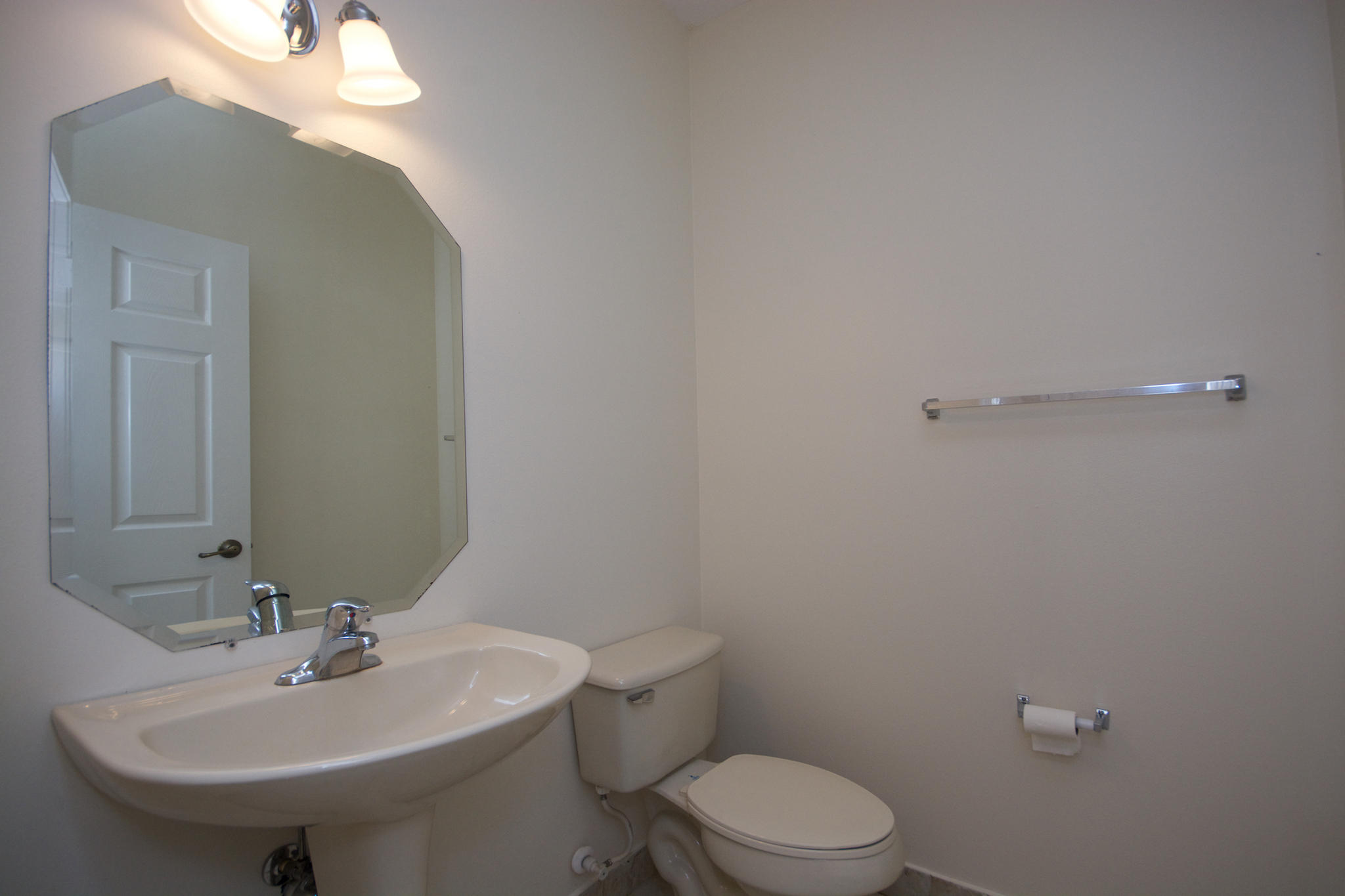 3227 Laurel Ridge Circle Riviera Beach, FL 33404 - Photo 14 of 27 a bathroom with a sink a toilet and mirror