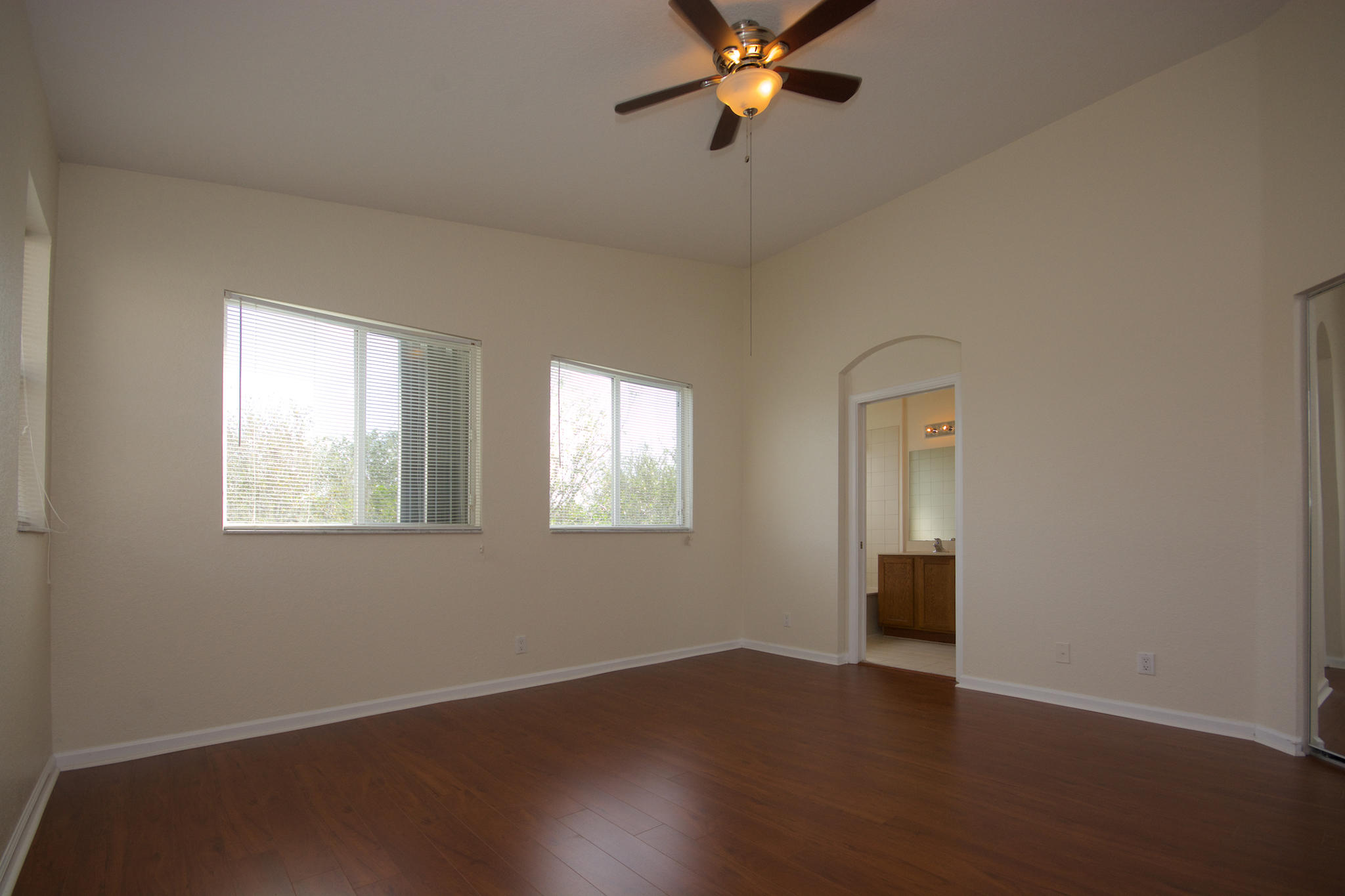 3227 Laurel Ridge Circle Riviera Beach, FL 33404 - Photo 21 of 27 a view of an empty room with wooden floor and a window