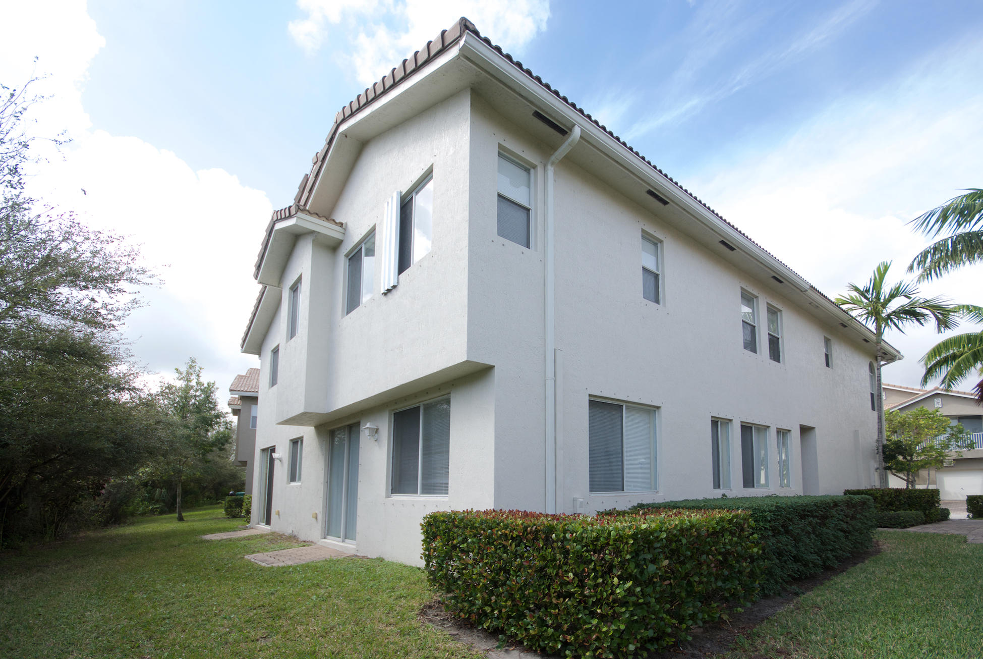3227 Laurel Ridge Circle Riviera Beach, FL 33404 - Photo 3 of 27 a front view of a house with a yard