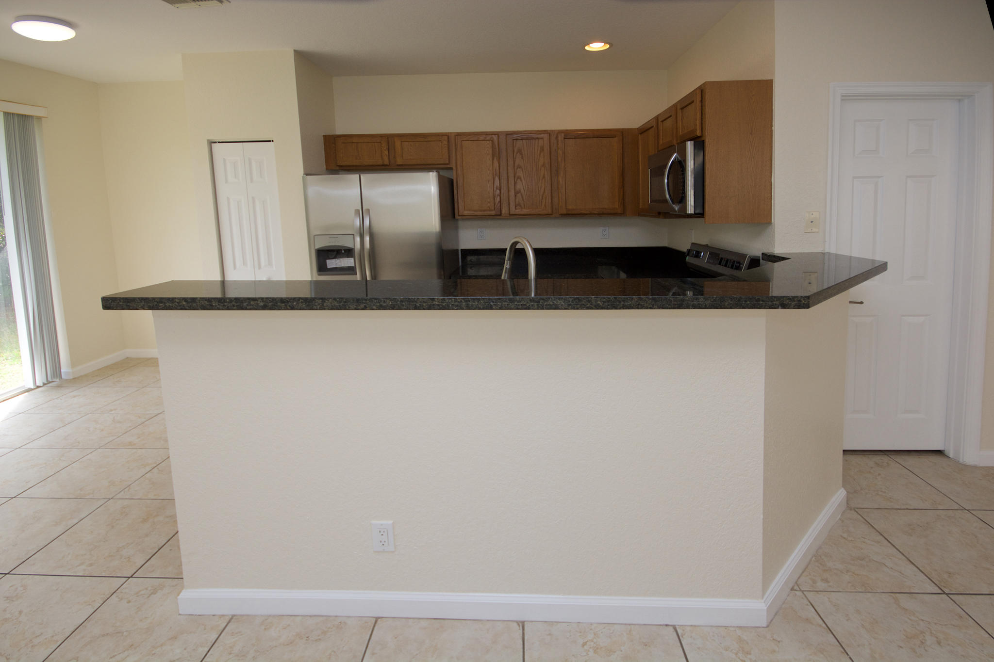 3227 Laurel Ridge Circle Riviera Beach, FL 33404 - Photo 10 of 27 a kitchen with stainless steel appliances a refrigerator and microwave
