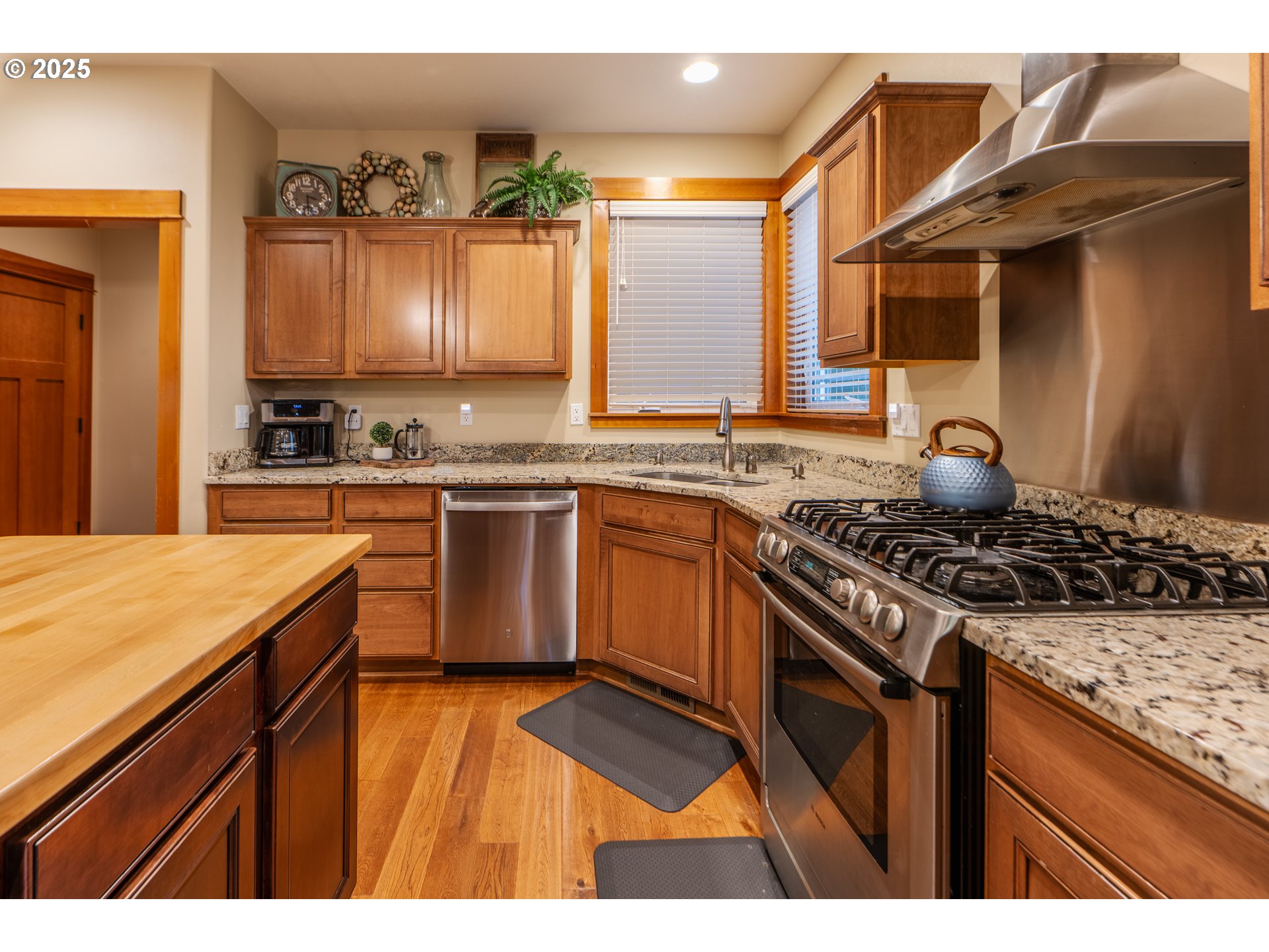 1110 Redtail Loop Hood River, OR 97031 - Photo 21 of 37 a kitchen with stainless steel appliances granite countertop a stove a sink dishwasher and cabinets with wooden floor