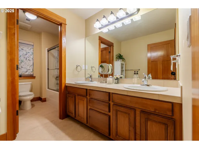 a bathroom with a sink a toilet and a mirror